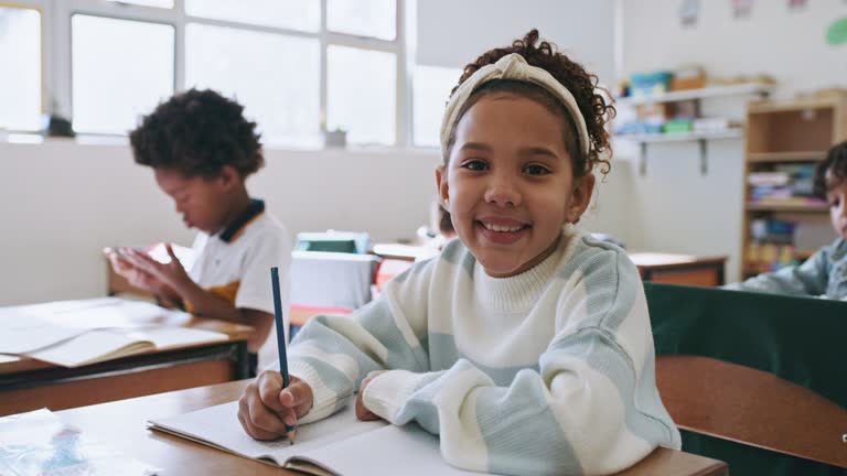 School, face and black child learning language, education and classroom writing development. Young USA student, children or smart, happy girl with book for knowledge, goals or creative notes portrait