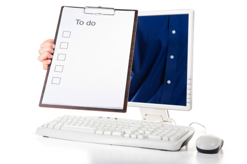 A man is holding to do list from inside computer's screen to remind you.