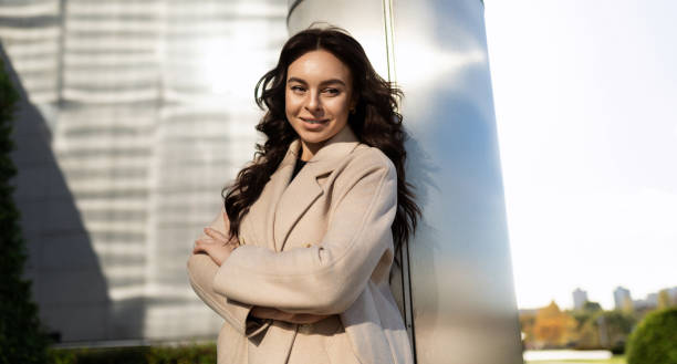 istock confident business woman smiling looking at camera outside 1472494970