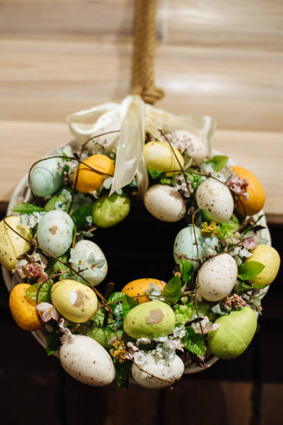 istock Wreath of branches on white background with colorful easter eggs. Home and interior decoration. Spring easter composition 1472495269
