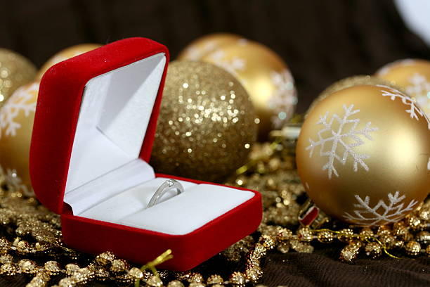 istock Engagement ring in red box with xmas decoration 147249541