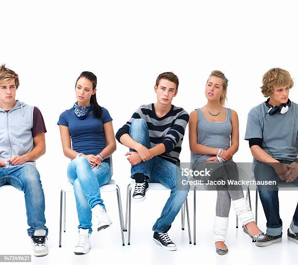 Men And Women Sitting On Chairs In A Line Stock Photo - Download Image Now - Front View, In A Row, Sitting