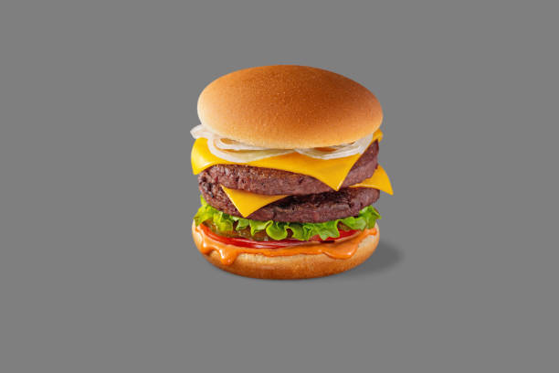 istock Double Cheeseburger with artificial meat, fresh onion, lettuce, pickles, fresh tomato and paprika sauce. Burger stands on a gray background. 1472497548