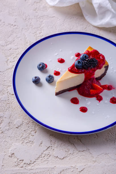 istock Napoleon with powdered sugar, blueberries, strawberries, blackberries and jam in a plate that stands on rough concrete with a cloth on the background 1472497674