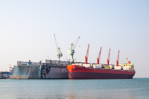 Industrial cargo ships in the harbor at mornin