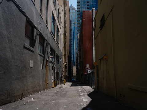 A city alley showing high rise in the background