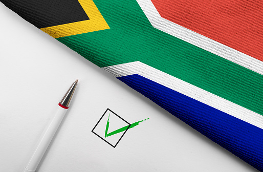 pencil, flag off South Africa and check mark on paper sheet