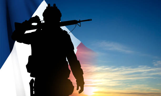 Silhouette of French soldier on background of sky and French flag Silhouette of French soldier against the sunset and French flag. Concept - Armed Forces. EPS10 vector conflict stock illustrations