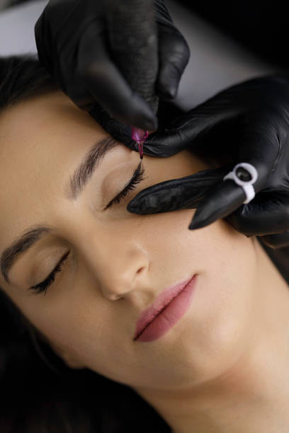 istock Permanent eye make-up application by a make-up artist in a beauty salon 1472499940
