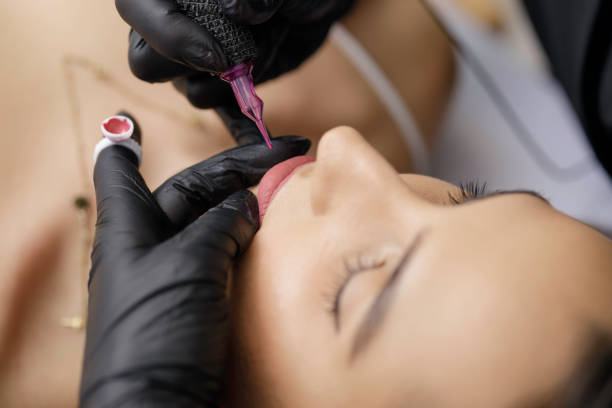 istock Permanent lip make-up application by a make-up artist in a beauty salon 1472500568