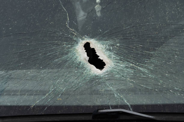istock Abstract image of broken glass texture, background. Close-up of a broken car windshield. Broken and damaged car. 1472504359
