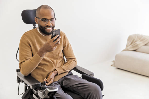 istock Young Black Man Using Smartphone in Living room 1472504546