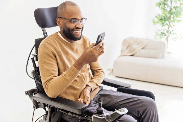 istock Young Black Man Using Smartphone in Living room 1472504569