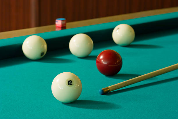 Five balls and cue Four white billiard balls and a red ball with a cue at the green table number 12 pool ball ball number stock pictures, royalty-free photos & images
