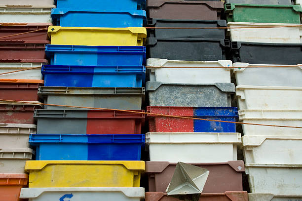 Piled up plastic boxes used for transportation over water. These boxes come from all over the world to Hollands biggest harbour, port of Rotterdam
