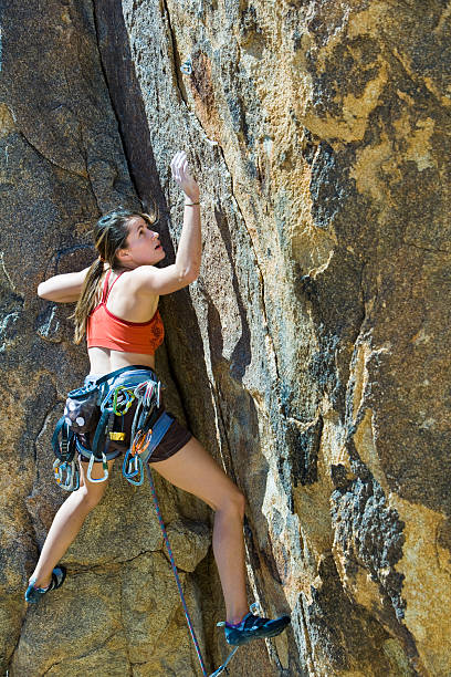 istock Female climber clinging to a cliff. 147250734