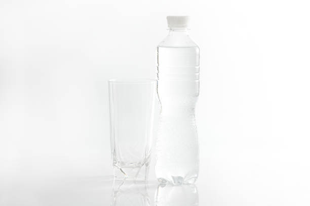 istock Empty glass and water bottle on white background 1472507919