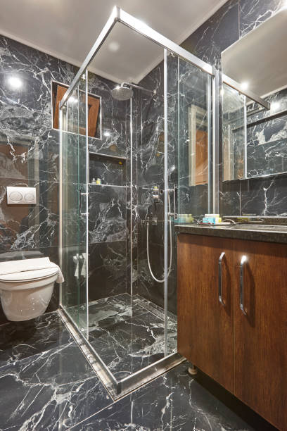istock Luxury bathroom decorated in black marble ties. Classic bath indoor 1472509974