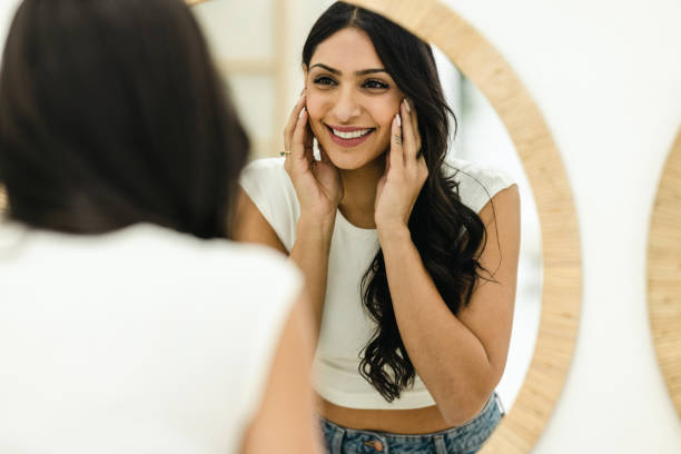 istock Young Woman Putting Face Cream 1472512545
