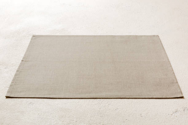 istock Perspective view of grey tablecloth for food on cement background. Empty space for your design 1472513792