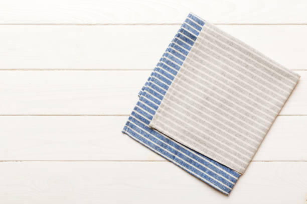 istock top view with gray kitchen napkin isolated on table background. Folded cloth for mockup with copy space, Flat lay. Minimal style 1472513901