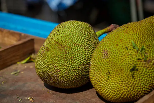 Photo of Fresh jackfruit in wooden box for sale at market