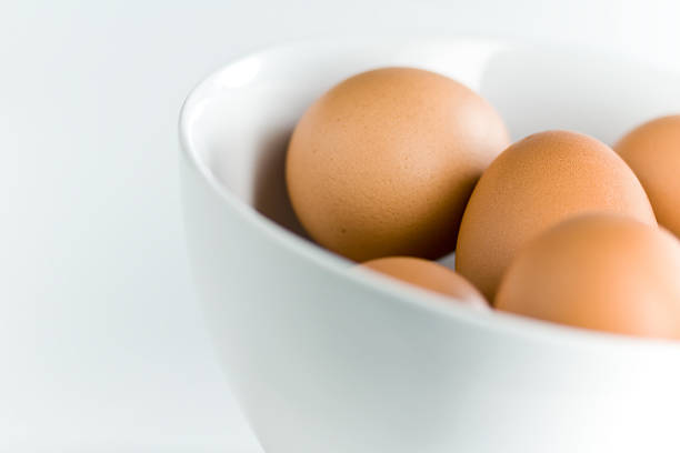 Fresh Brown Eggs in Tilted White Bowl stock photo