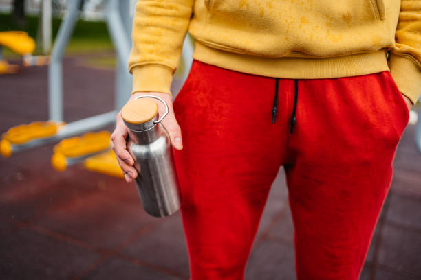istock Young Athletic Man Holding A Water Bottle Outdoors In The Rain 1472514368