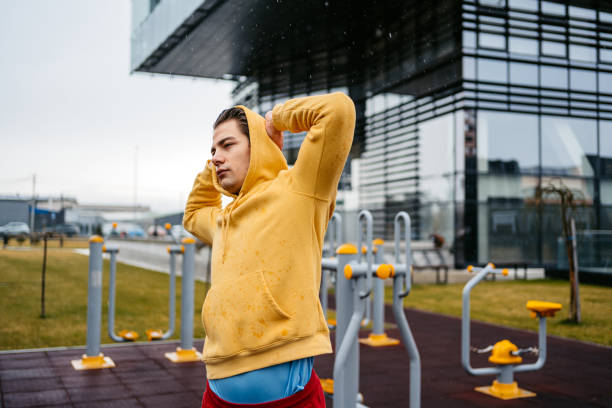 istock Young Man Stretching Before A Workout Outdoors In The Rain 1472514645