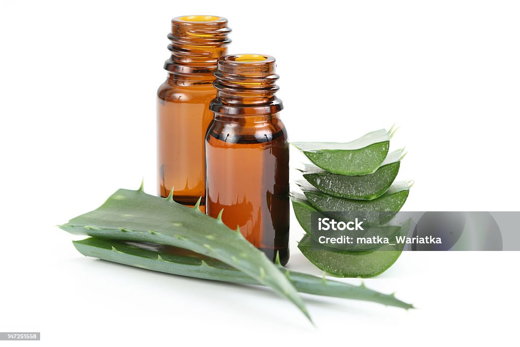 aloe vera essential oil two bottles of aloe vera essential oil isolated on white Aloe Vera Plant Stock Photo