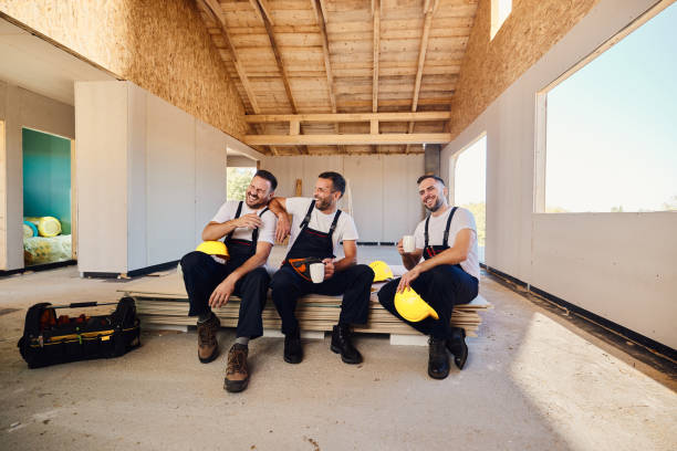 istock Cheerful manual workers having fun on a break at construction site. 1472515860
