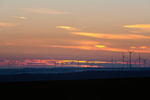 istock Wind turbines generate energy power electricity during the evening. 1472516172