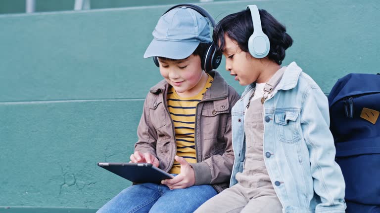 Children, headphones or digital tablet on school steps for fun games, education music or development learning radio. Smile, happy or bonding kids on technology for friends, students or growth podcast