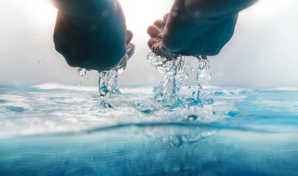 istock Hand Scooping and Pouring Water. Freshness and Clear. World Water Day Concept. Environmental Care and Sustainable Resources. Social Responsibility 1472520978