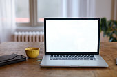 Close-up of laptop with white screen on table