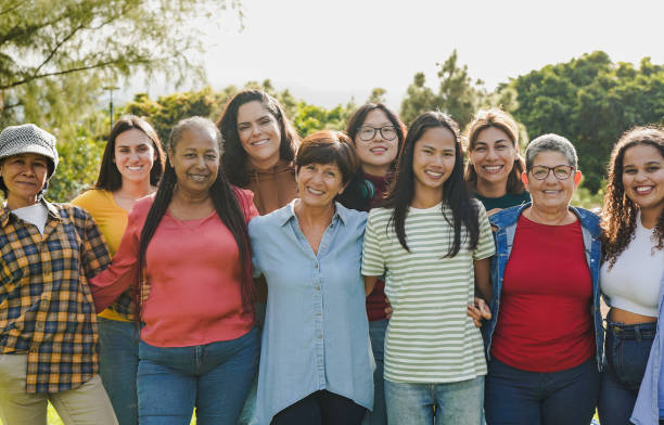 istock Group of multi generational women hugging each other while smiling on camera 1472522846