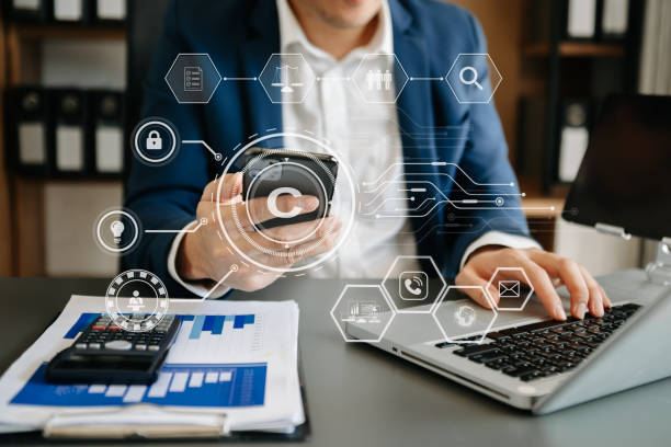 istock Copyright or patent concept, Person hand using laptop computer, tablet and smartphone with virtual screen copyright icon trademark, Creation ownership against piracy. 1472523364