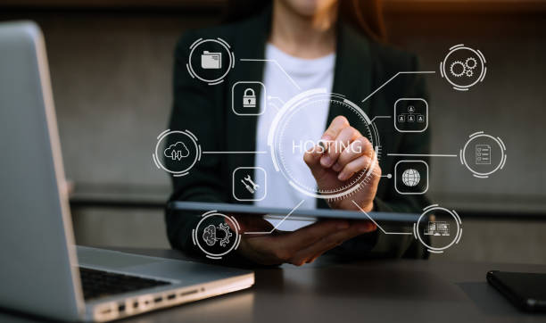 istock Web hosting concept, woman using computer, tablet and presses his finger on the virtual screen inscription Hosting on desk, Internet, business, digital technology concept. 1472523387