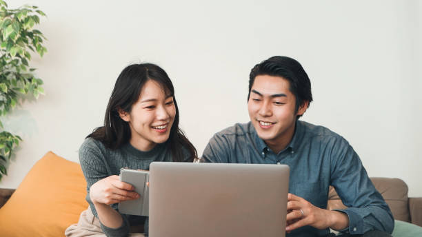 istock Japanese Couple Using A Laptop 1472525371