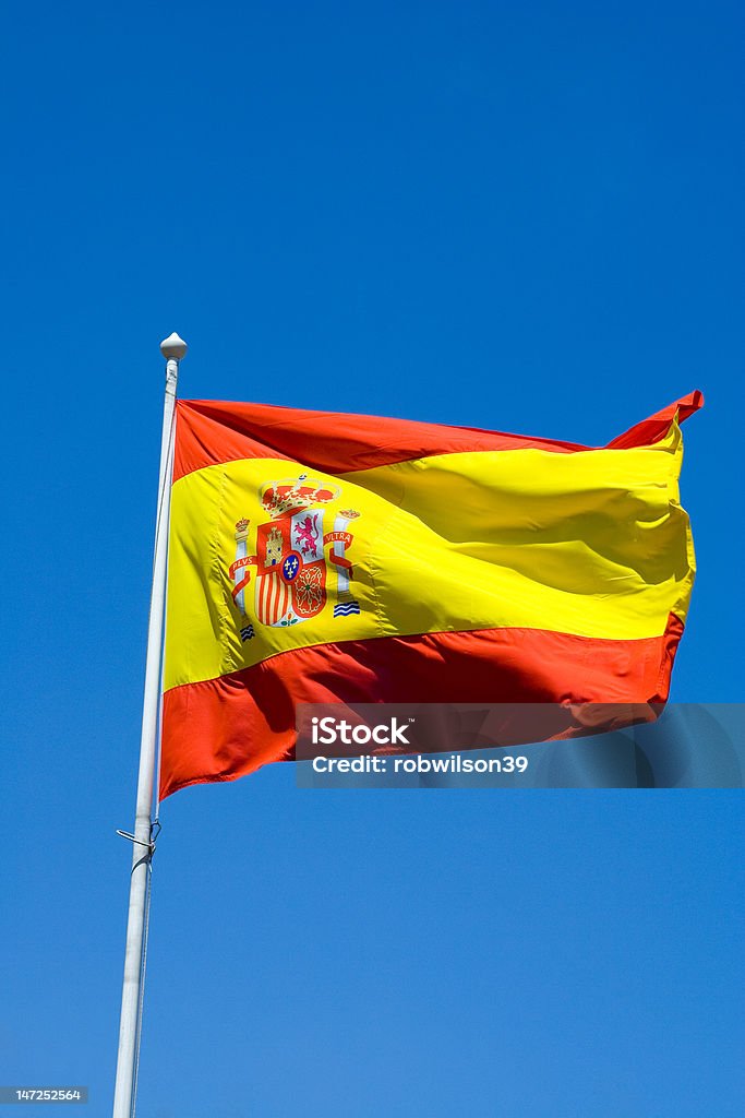 Flag of Spain Flag of Spain Blowing in the Wind against a Blue Sky Blue Stock Photo