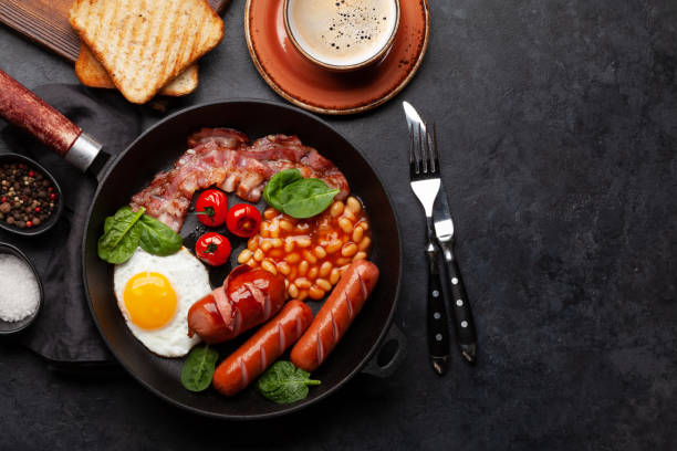 istock English breakfast with fried eggs, beans, bacon and sausages 1472526611