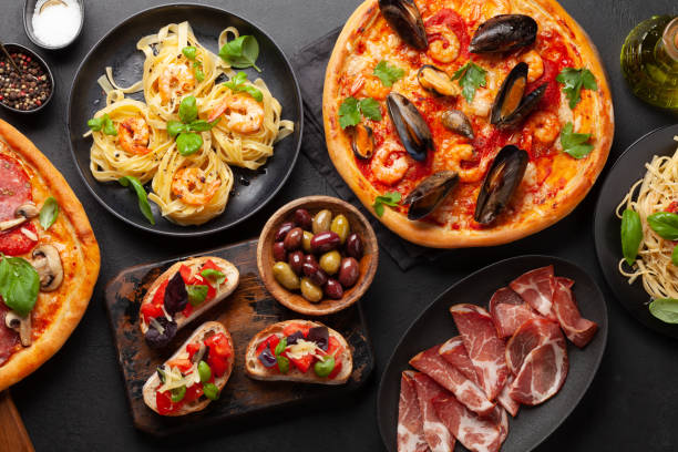 Italian cuisine. Pizza, pasta and toasts Italian cuisine. Pasta, pizza, olives and antipasto toasts. Flat lay seafood photos stock pictures, royalty-free photos & images