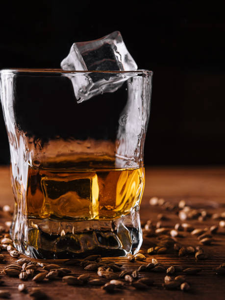 istock Glass of whiskey with ice and wheat 1472528683