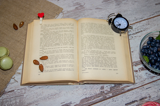 Open book on old wooden table