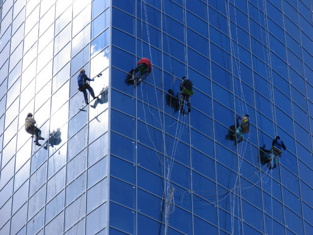 istock Six workers washing windows in the office building 147253055