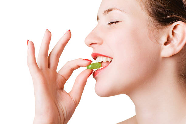 istock Girl with a green pill 147253094