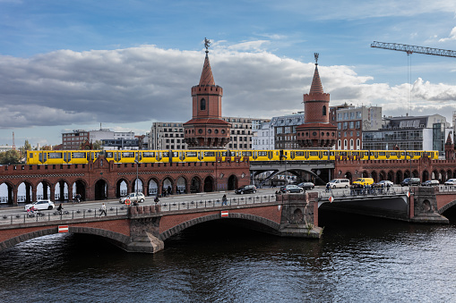 Yellow U-Bahn train crossing over the Oberbaum Bridge in Berlin