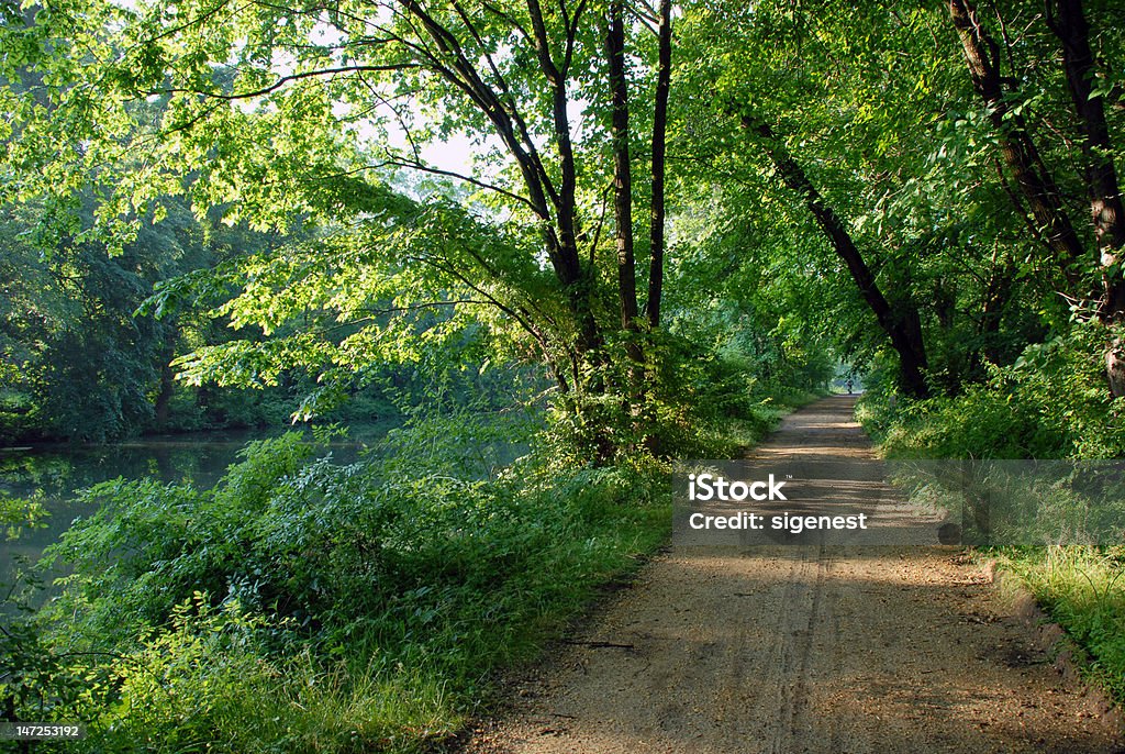 Canal trail A scenic trail in the park by the canal or river Arranging Stock Photo