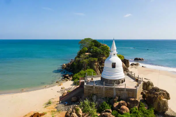 Buddhist monastery, stupa on the beach near the ocean. Sri Lanka.
