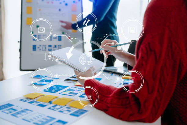 istock Close up view of UI developer team brainstorming on their project with laptop, smartphone and digital tablet. Creative digital development agency. 1472532271